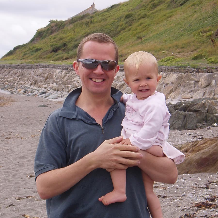 Ellie as a baby with her dad on the beach